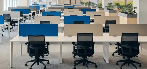 Modern open-plan office space featuring clean workstations, ergonomic chairs, and sanitized carpets provided by professional office cleaning services in Anaheim, CA.