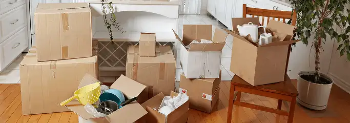 Packed moving boxes and household items in a kitchen before move-out or move-in cleaning, Anaheim, CA.